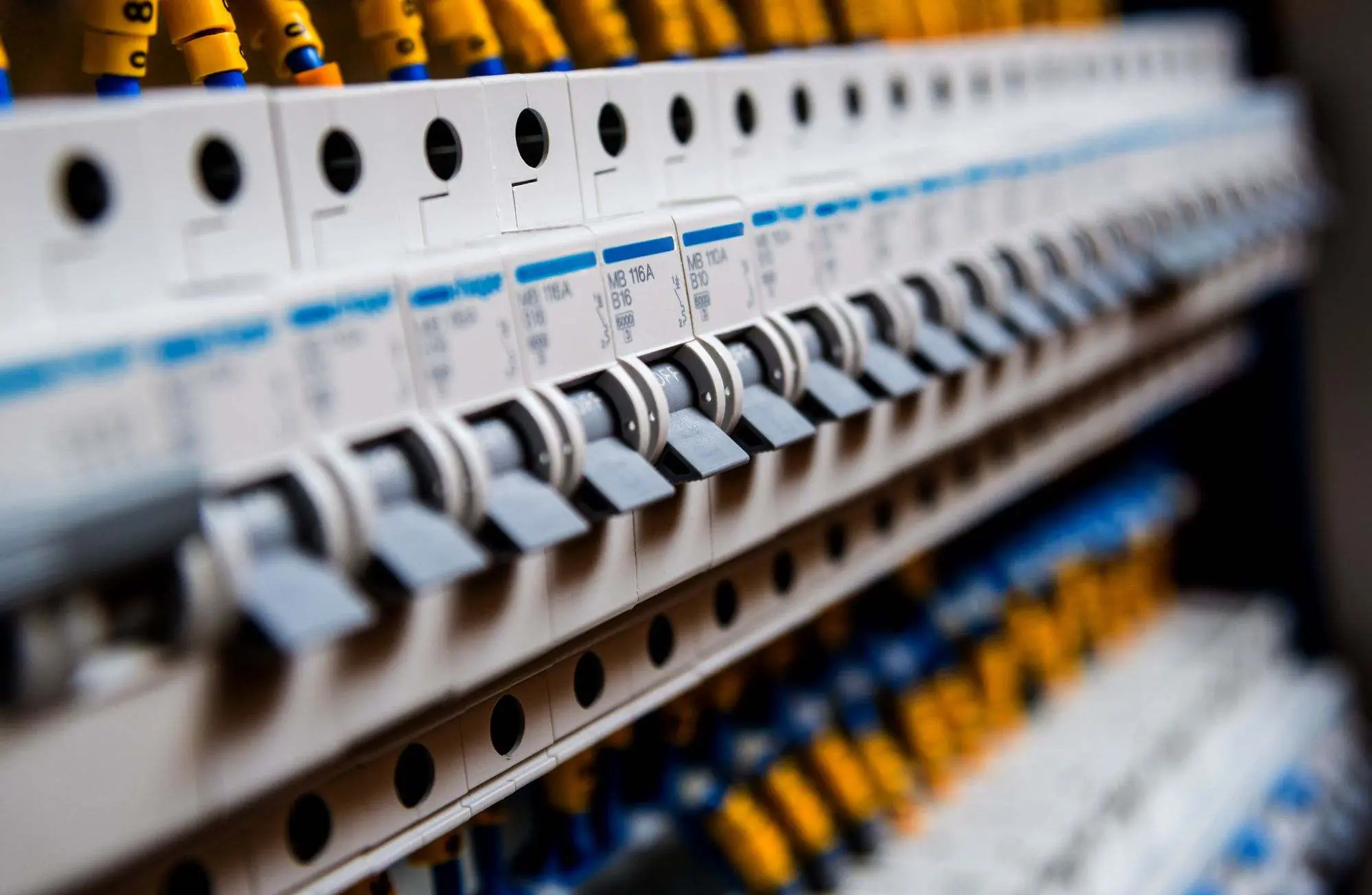 Close-up view of a circuit breaker panel with switches.